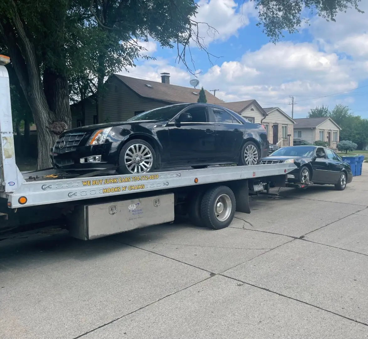 A car is being towed by a tow truck.